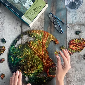 Hands assembling an artistic CogZart CircZles puzzle